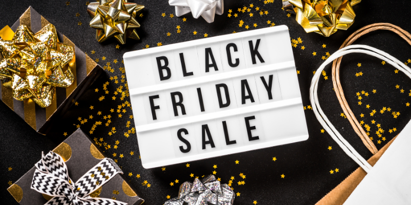 Black Friday Sale against black background with gold and silver presents.